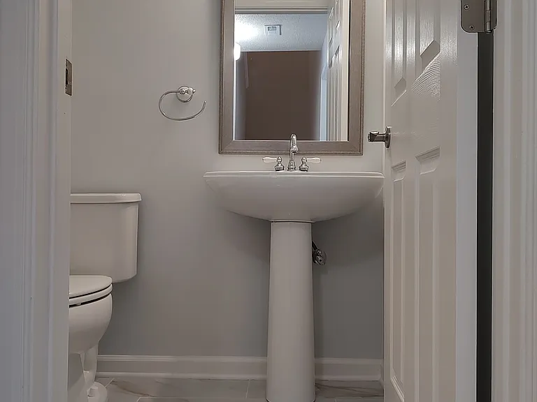 Downstairs 1/2 Bathroom with designer tile floor