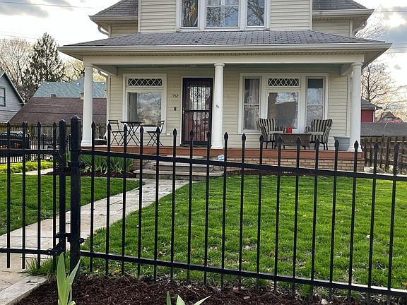 Limestone retaining, raised garden, and fence along front.
