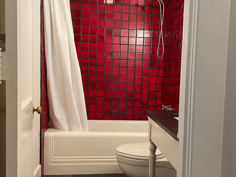 Art Deco red tile, tub w/ slate floor.
