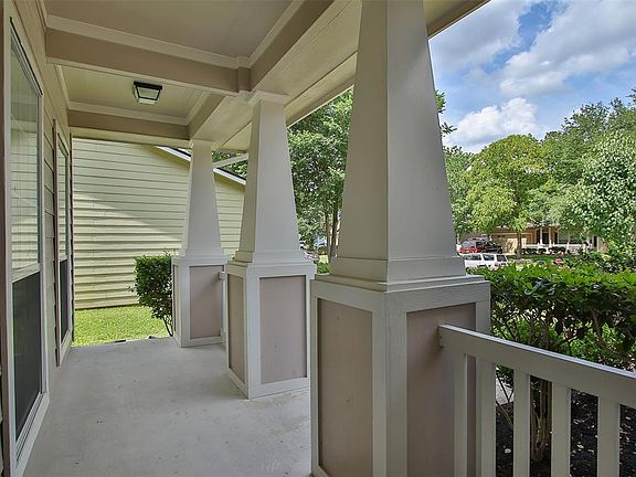 Cozy front porch, perfect for a sitting area, complete with white picket fence and craftsman style columns.