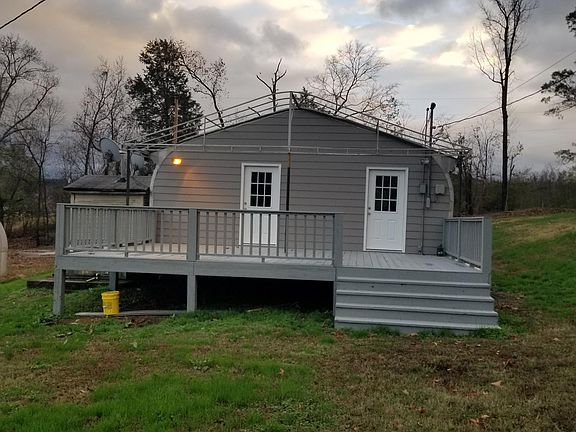 Rear of house. Newly framed rear wall, new siding and new doors. Deck sturdy and recently painted.