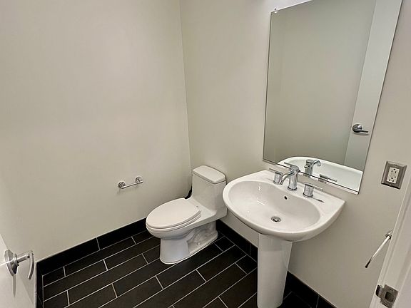 Powder bathroom off the main living area with modern LED lights and updated TOTO toilet.