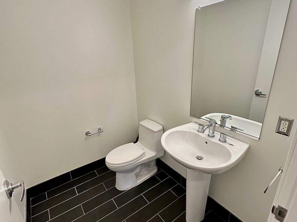 Powder bathroom off the main living area with modern LED lights and updated TOTO toilet.