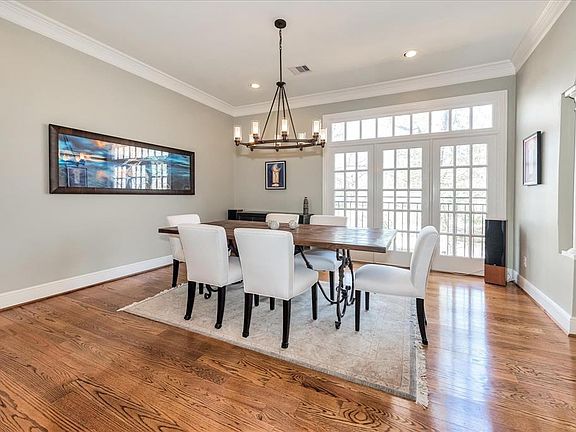 Gather with your loved ones in this dining room with a treetop view of the outdoors. This space accommodates oversize furniture and brings in the most brilliant and lovely lighting as you can see. Who wouldn't want to dine here?!?
