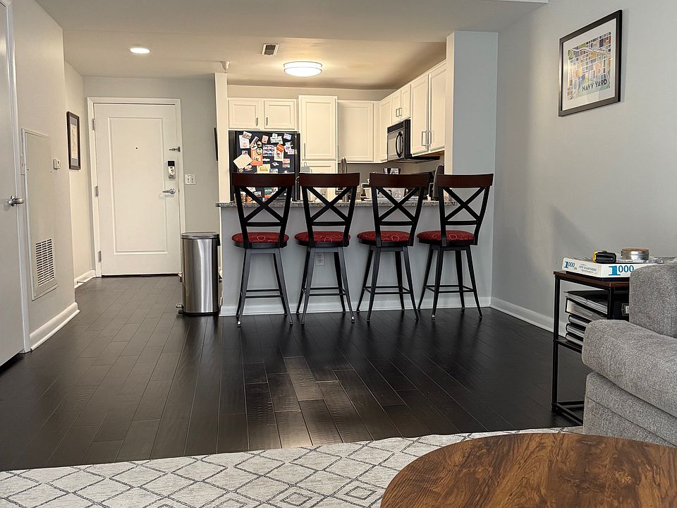 Living Room view of dining area, kitchen and condo entrance.