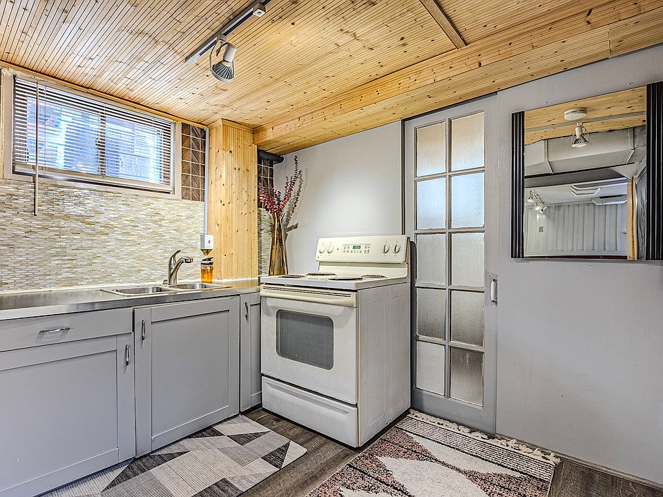 Kitchen sink area, window and entrance to bathroom