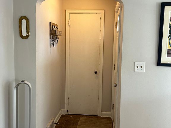 Curved archway to front door/ front hall closet