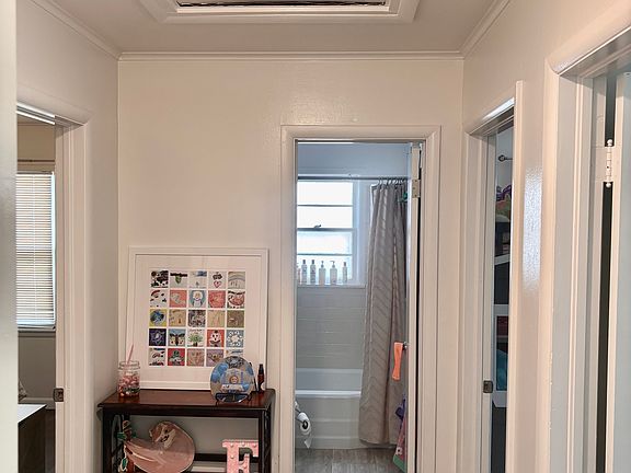 looking from living room to the hallway with 3 bedrooms and a bathroom.