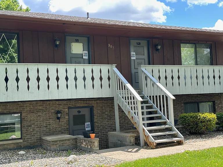 Studio exterior showing uppers with balconies and garden levels.