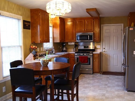 The kitchen has stainless steel appliances, a fun chalk wall