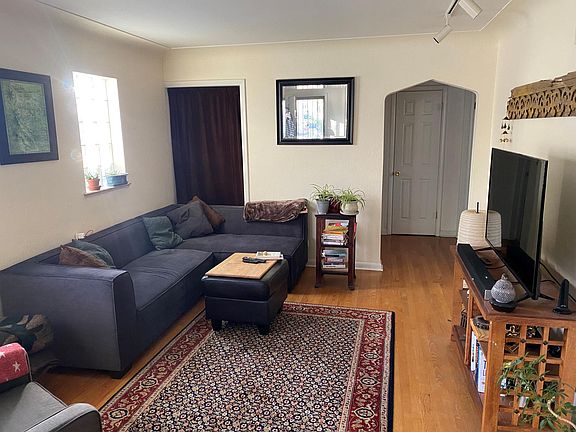 Living room. Additional storage closet on rear left and linen closet through archway.