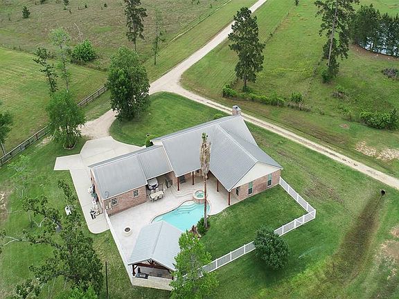 View of home with fence around backyard and pool area.
