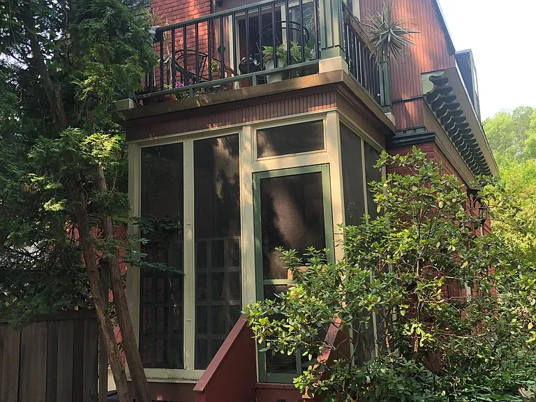 Back of house showcasing private screened-in porch and open-air balcony