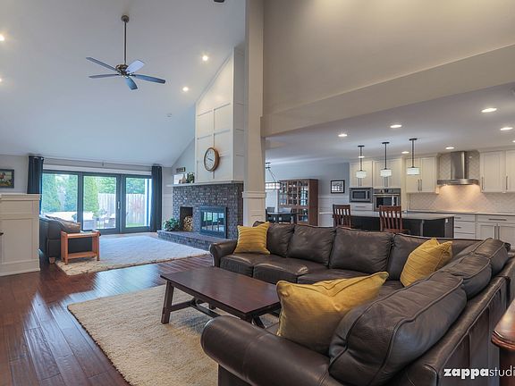 Open floor plan with soaring vaulted ceilings.