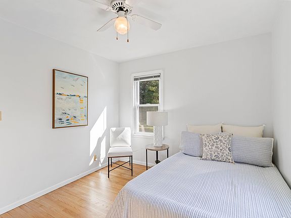 Bedroom 2 overlooks grassy backyard & woods