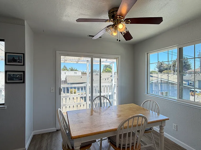 dining area off kitchen with sunny deck