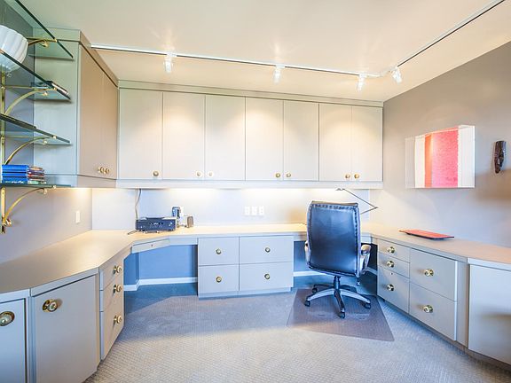 Built-in cabinetry provides a large home office space. From