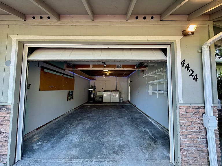 Spacious automatic garage with plenty of storage shelves