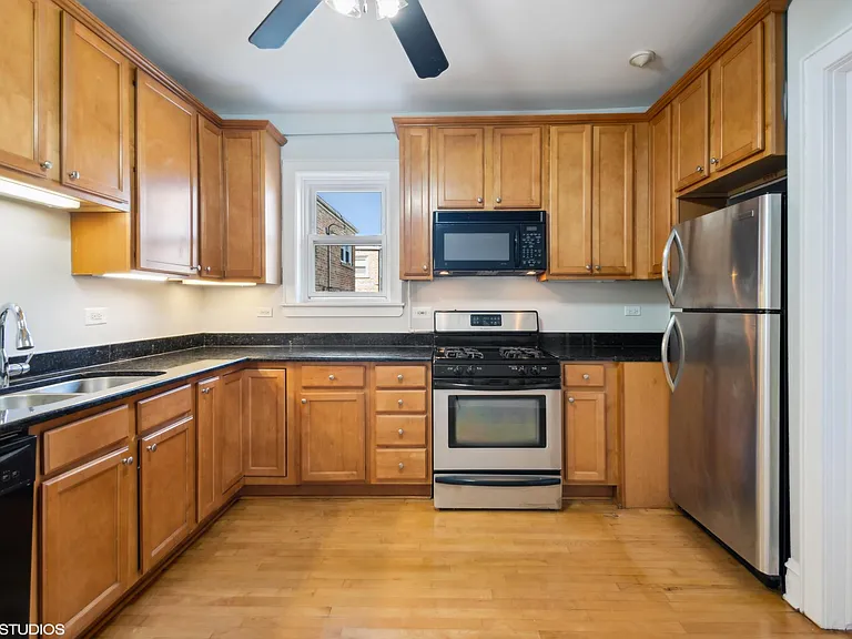 Large kitchen with gas stove, microwave & granite counters.