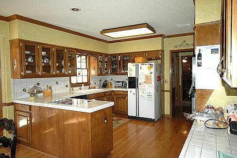 Bright Open Kitchen With Hardwood Floor & Tile Counters
