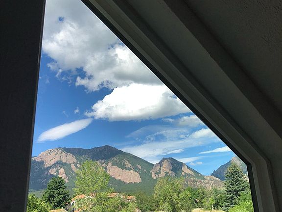 The view of the Flatirons and open space out of this window is on the first floor between the living room and the stairs.
