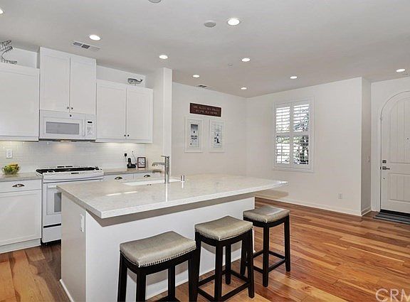 immaculate home with beautiful wood floors and upgraded quartz counters