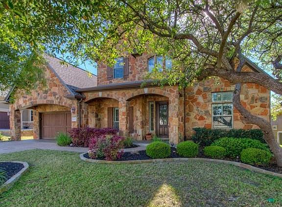 Nicely landscaped with sprinkler system and wrought iron fence.
