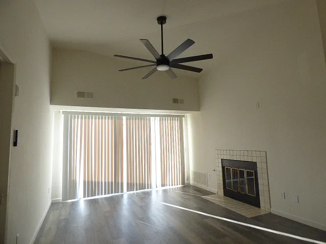 Living room with fire place and ceiling fan