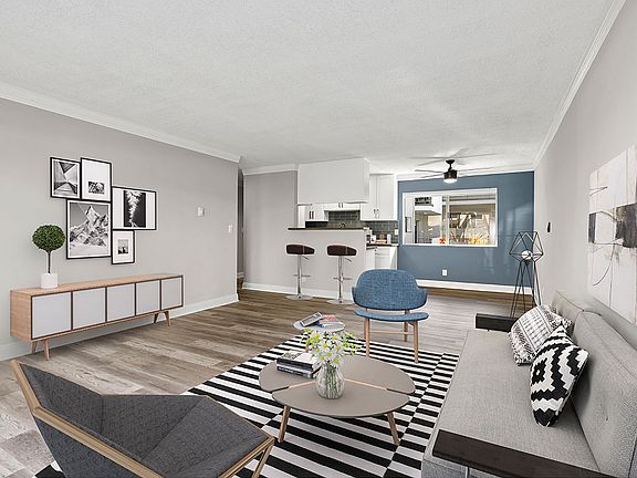 Living room with hardwood floors and blue accent wall.