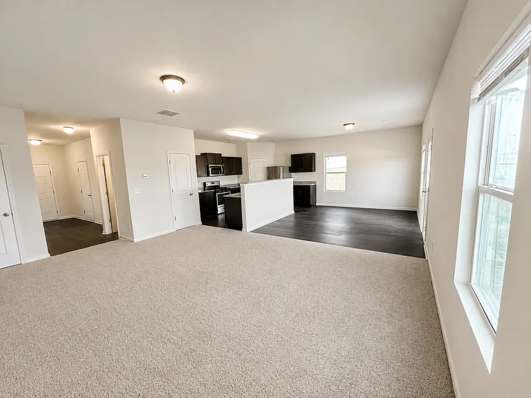 Unfurnished living room with carpet flooring