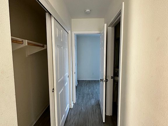 The bedroom hallway on the first floor. Closet on the left and full bathroom on the right.