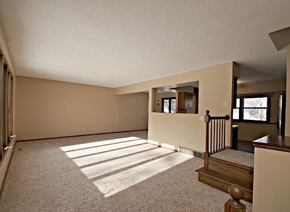 Main level living room with lots of natural light, open floor plan, plus new carpet and paint throughout!