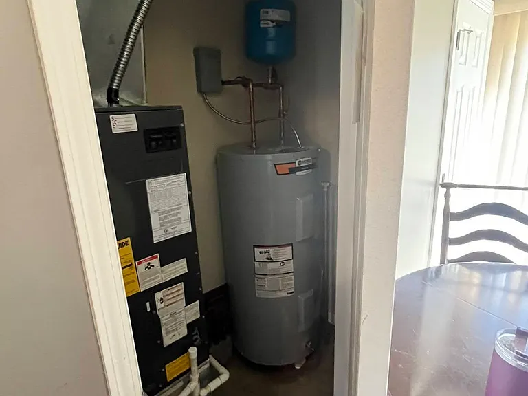 Furnace and Water heater closet behind dining table.