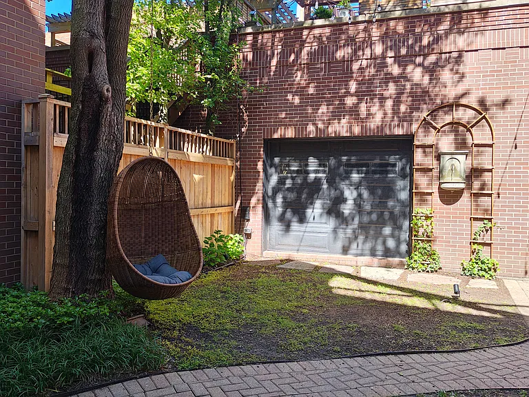 Backyard with tree swing and fountain.