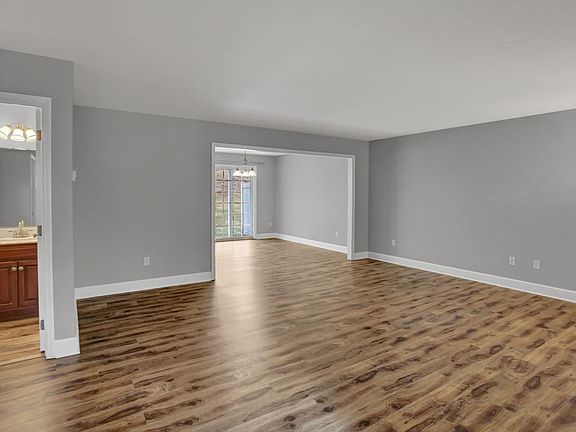 Large living room with the half bath and is open to the dining room