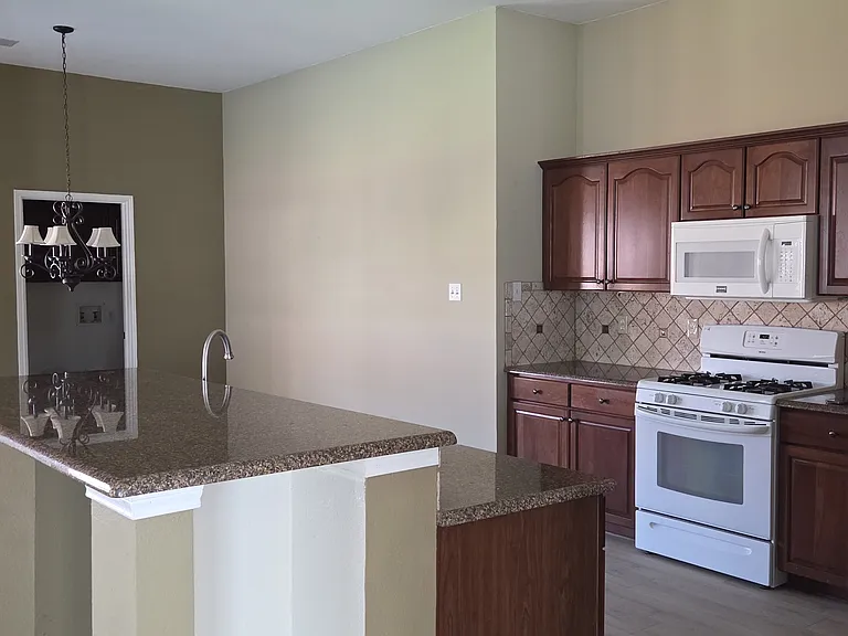 View of kitchen island, kitchen abd breakfasr