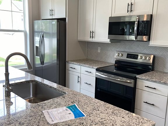 Kitchen with Granite countertop and bar area. More pictures after painting complete.