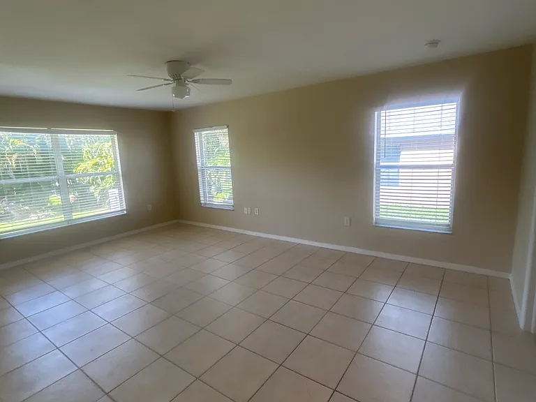 Master bedroom, three windows, and two closets in the master bath
