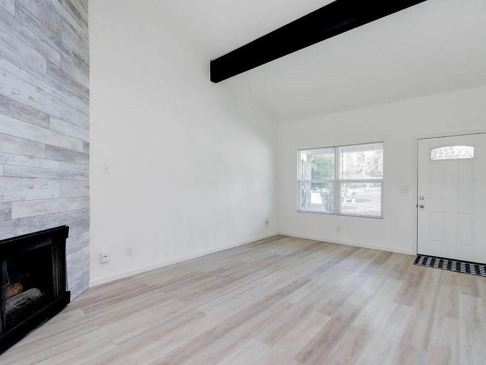 Living room w/fireplace and skylight