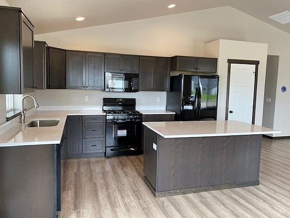 Kitchen with pantry. Gas range, microwave, fridge, and garbage disposal. Soft close on all cabinets and drawers.