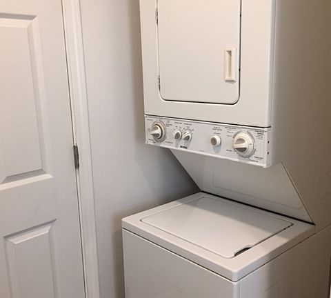 Washer and Dryer behind door at bathroom