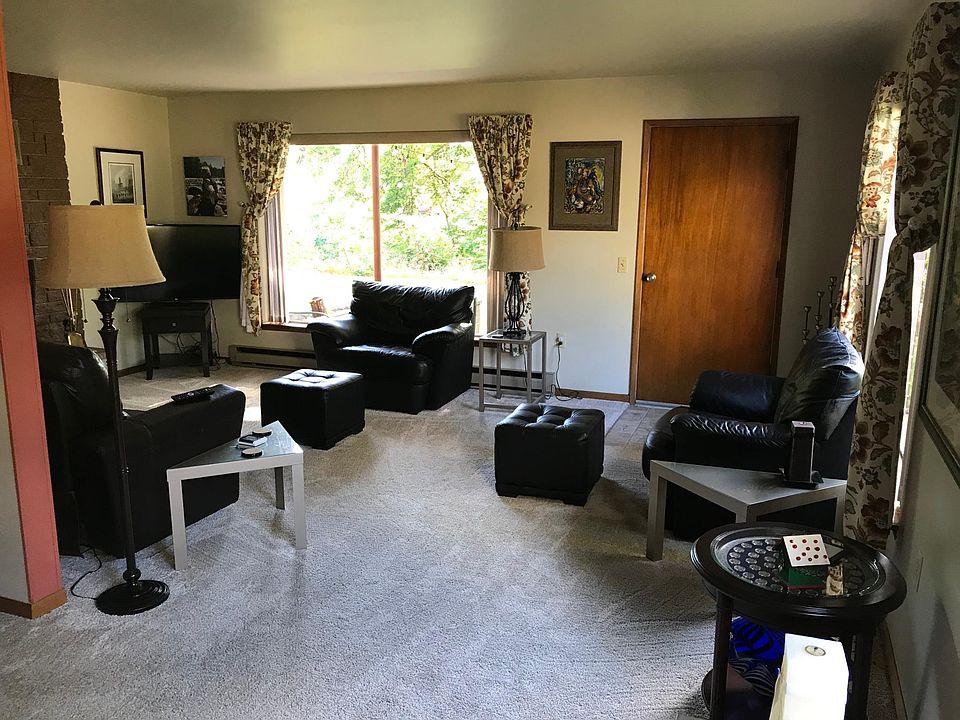 The door in the living room goes out to a covered patio with a planter on two sides.