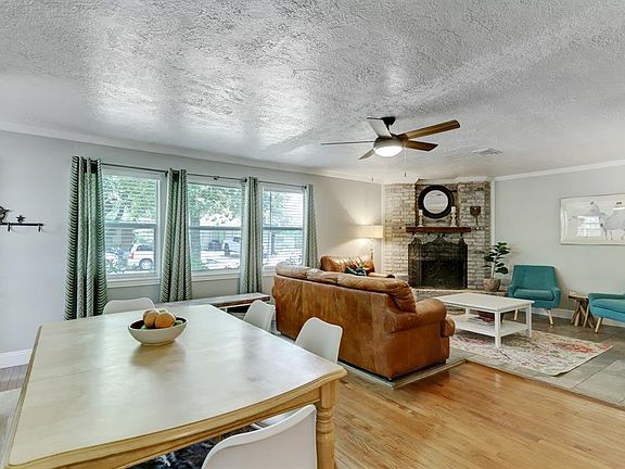 View of the dining room that overlooks the kitchen and living room. Recent updated windows throughout help shield the summers.