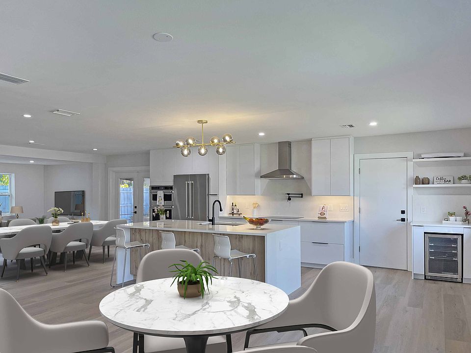 Spacious open-concept kitchen and dining area with modern finishes, quartz countertops, and built-in beverage center _ perfect for entertaining.