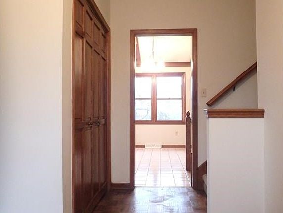Nice bright entry way with original hard wood floor, tall vaulted ceiling, fresh paint, new light fixture and coat closet for guests.