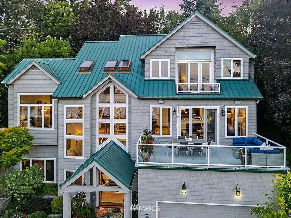 Exciting and dramatic transitional style resale, originally custom built by RKK Construction and located on the convenient north end of Mercer Island.  All kinds of quality here including shingle siding on all sides of the house, metal roof, clad windows and dramatic architecture.