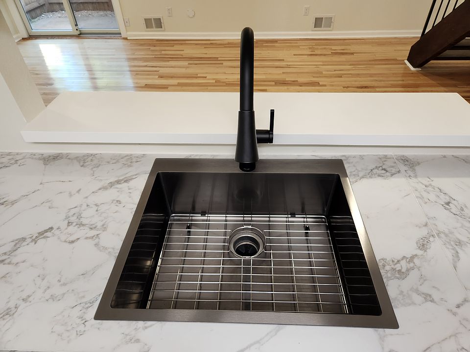 Brand new black stainless steel sink with rack, garbage disposal and facet with a built-in light + two spray options!
