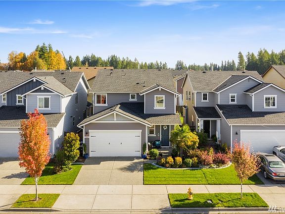 Front of home, beautifully landscaped with upgraded concrete curbing for easy mowing and edging!
