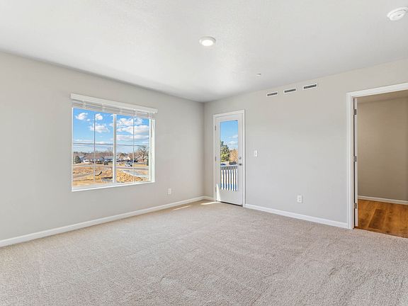 The master bedroom is spacious with a large window.