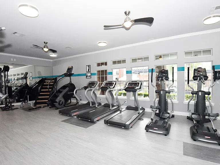 Modern fitness center with equipment for strength, cardio, and convenience
